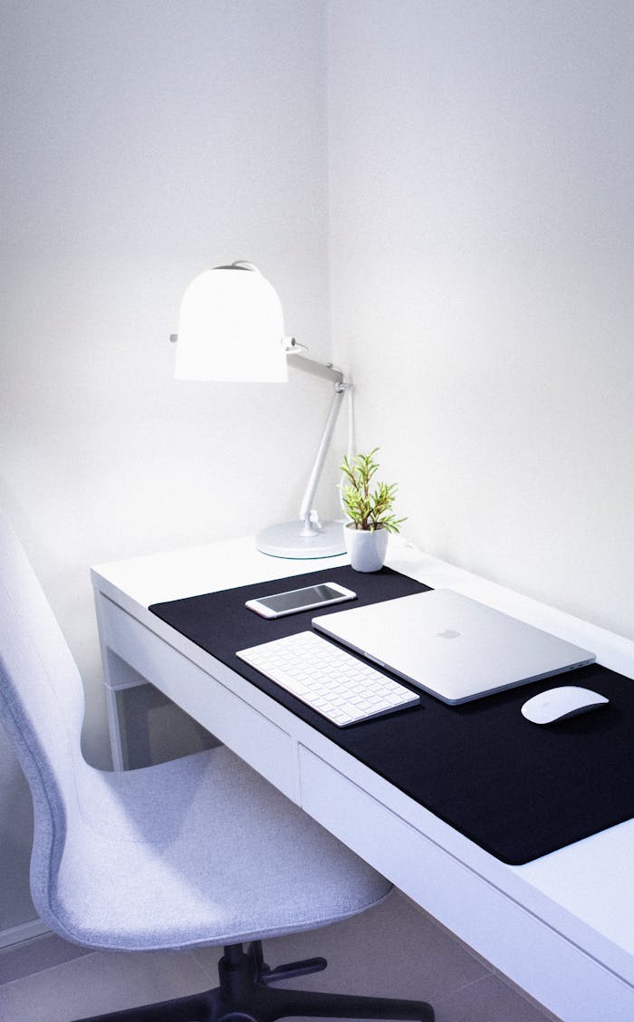 creative-03 Sleek, modern home office setup featuring Apple devices, a desk lamp, and a plant.