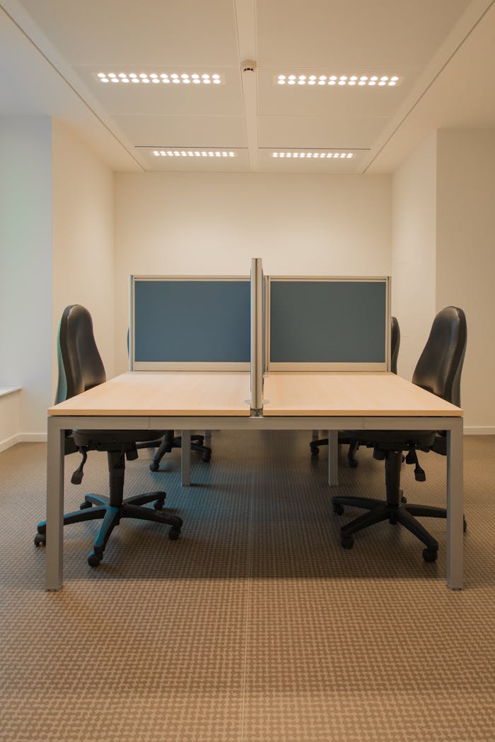 why-choose-us Contemporary office space featuring partitioned desks and ergonomic chairs.